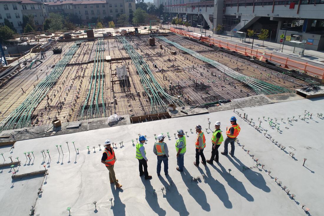 Construction Site with 6 Construction workers talking